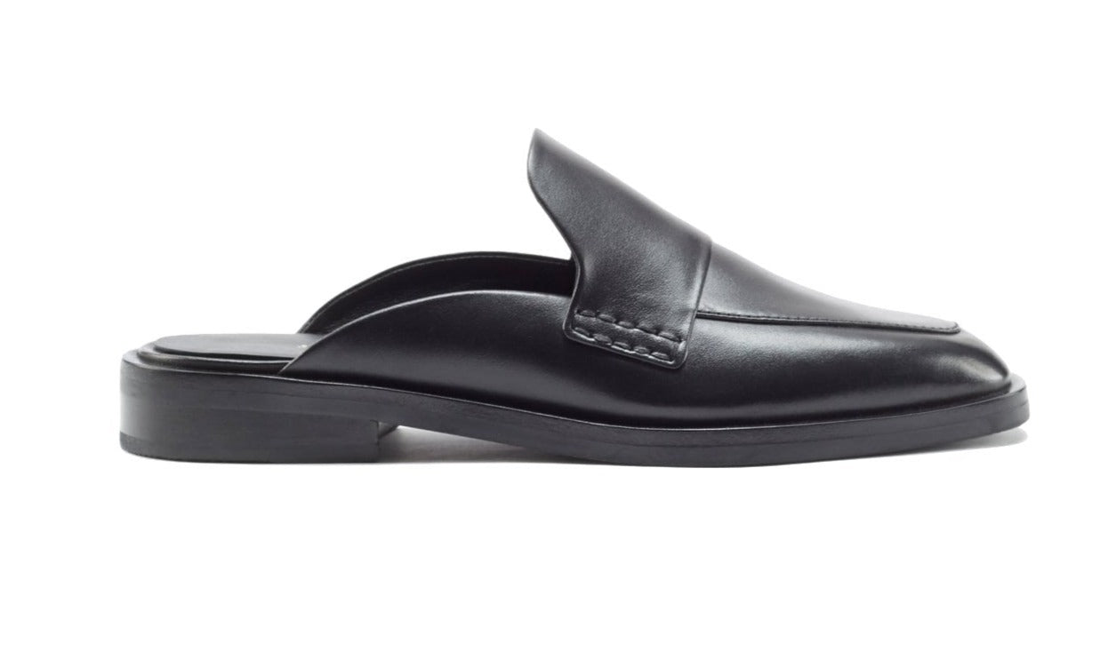 A sleek black 3.1 Phillip Lim Alexa Loafer Mule, crafted from smooth calf leather with a low heel, seen from the side against a white background.