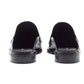 Rear view of a pair of 3.1 Phillip Lim Alexa Loafer Mules in smooth black calf leather, featuring a low heel and backless slip-on design, shown against a plain white background.