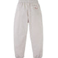 The Boys’ Alessio French Terry Jogger Pants by Gingersnaps are shown from the back in light gray, featuring an elastic waistband, cuffed ankles, and a small embroidered back pocket on the right with a red animal outline.