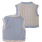 Two sleeveless children’s vests from Gingersnaps are shown; one is the Girls’ Eulalia Floral Reversible Vest, featuring a light blue fleece sherpa back, while the other displays an allover small floral print. Both have light blue trim and are displayed with their backs facing up.