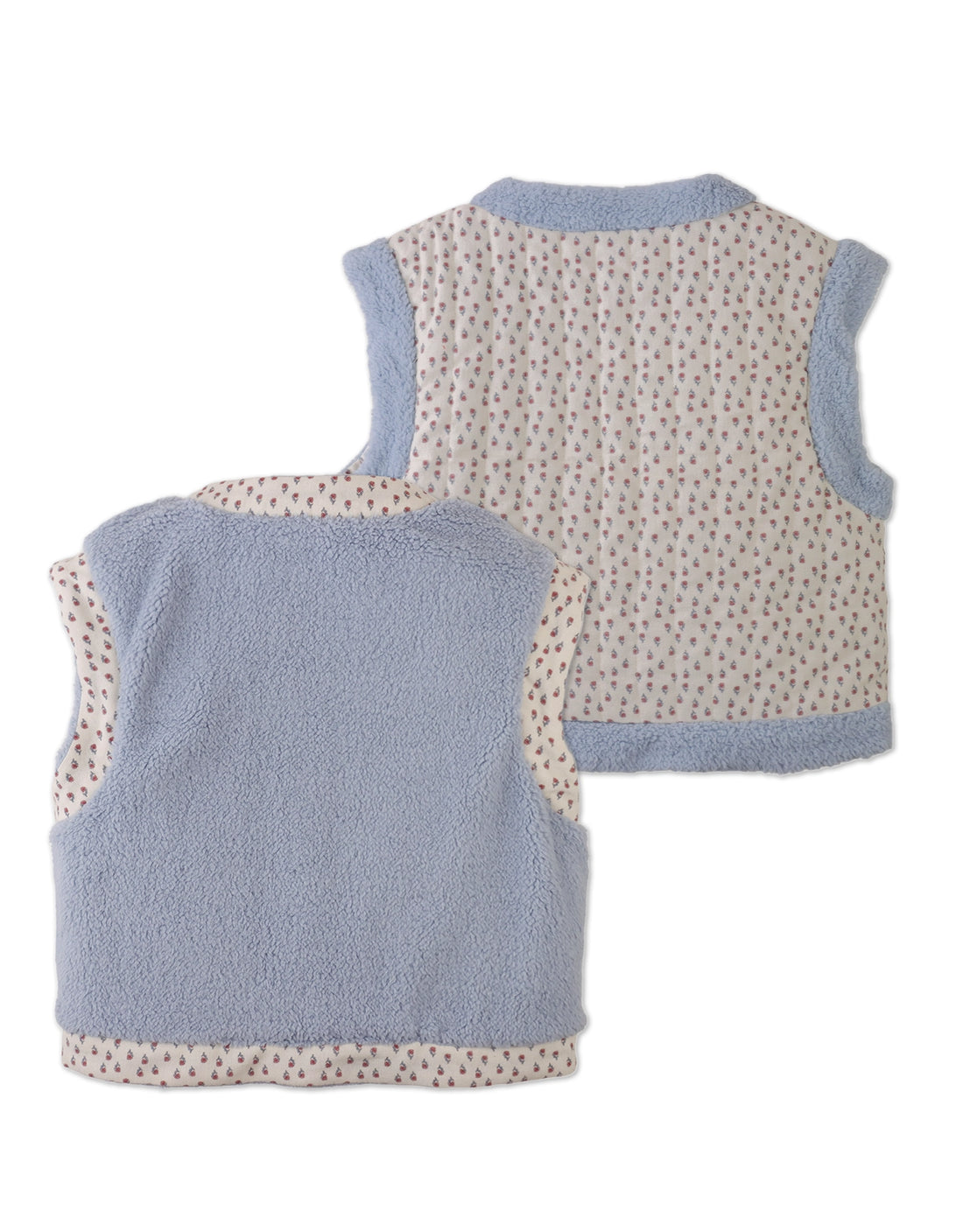 Two sleeveless children’s vests from Gingersnaps are shown; one is the Girls’ Eulalia Floral Reversible Vest, featuring a light blue fleece sherpa back, while the other displays an allover small floral print. Both have light blue trim and are displayed with their backs facing up.