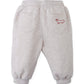 Gingersnaps Baby Boys’ Alessio French Terry Jogger Pants are light gray toddler sweatpants made from soft French terry fabric, featuring an elastic waistband and cuffs for comfort. These cozy joggers have two back pockets and a small red dog outline embroidered on the right pocket.