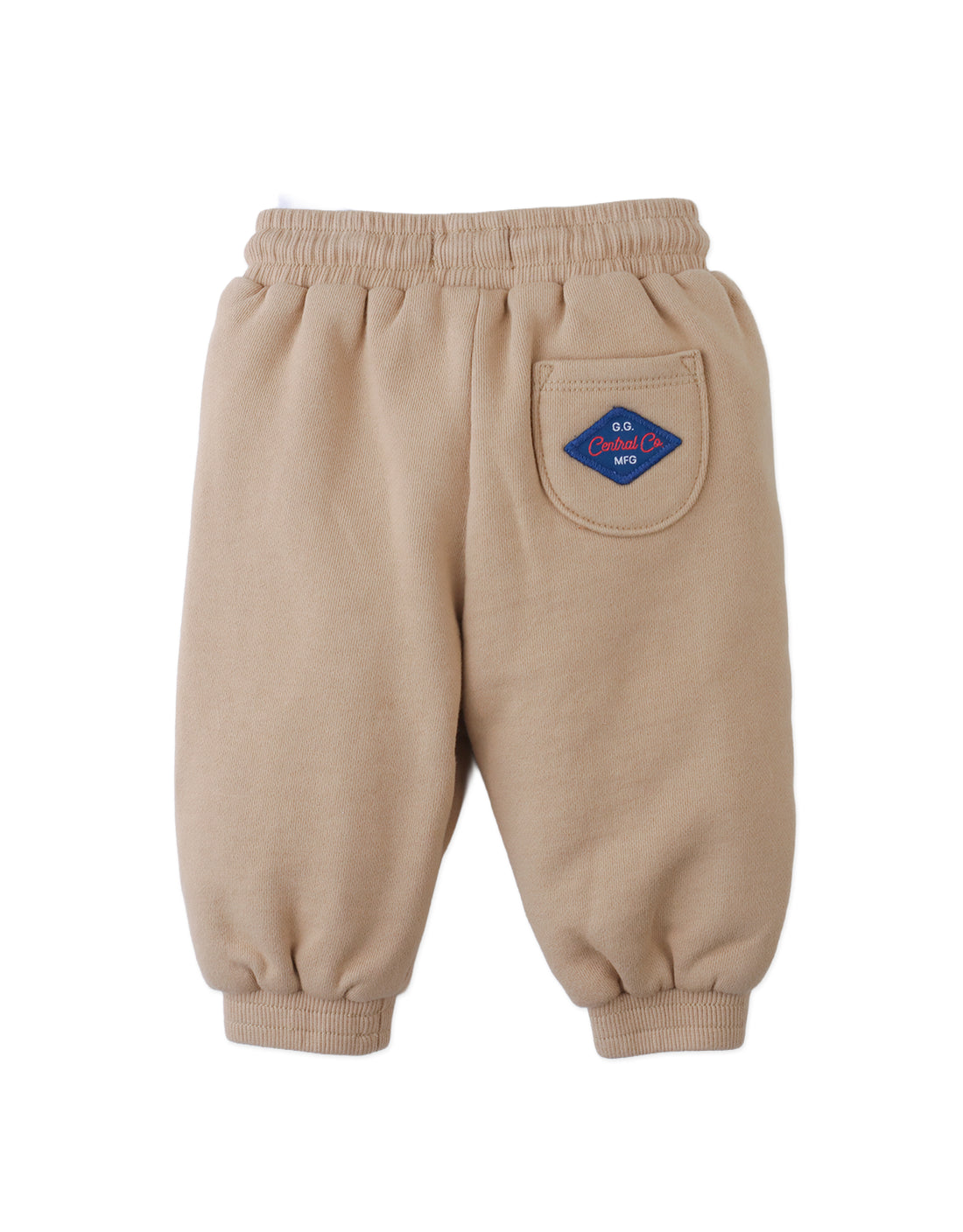 The Gingersnaps Baby Boys’ Fiulio Joggers are tan jogger pants featuring a blue patch on the back pocket, cozy pintuck details, and an elastic waistband and cuffs, displayed on a white background.