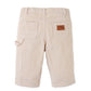 The Gingersnaps Baby Carmine Corduroy Utility Pant in beige is shown from the back, featuring two rear pockets, a side loop, and a brown patch label on one pocket—an essential comfy street style piece inspired by classic corduroy pants.