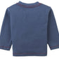 The Gingersnaps Baby Boys’ Myron Graphic Tee is pictured from the back, featuring long sleeves in blue with red stitching accenting the collar, cuffs, and hem. An embroidered dachshund outline adds a playful touch to this charming graphic tee.