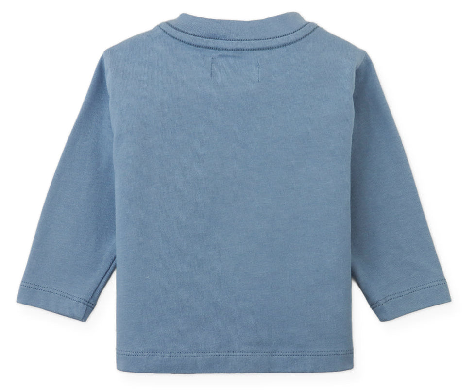 The Baby Boys’ Myron Graphic Tee by Gingersnaps is displayed laid flat with the back side facing up, showing its plain light blue color and long sleeves.