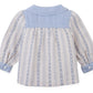 The Gingersnaps Baby Girls’ Hester Striped Floral Blouse features long sleeves, blue patterned stripes, a solid blue yoke and collar, and blue buttoned cuffs. Displayed flat with the back facing up, it’s the perfect cozy blouse for fall and winter.