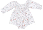 The Angel Dear Baby Girls’ Caitlyn Smocked All-in-One features long sleeves, a shirred bodice, and a delightful woodland animal print on a white background. Inspired by the beloved Caitlyn Smocked All-in-One Dress, this charming bamboo baby dress is perfect for special occasions or as an adorable baby party outfit.