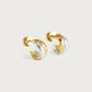The Anabel Aram Farrier Triple Huggie Hoop Earrings feature small, rounded hoops with a hammered texture and alternating gold and silver segments, creating a striking mixed metal look against a plain white background.