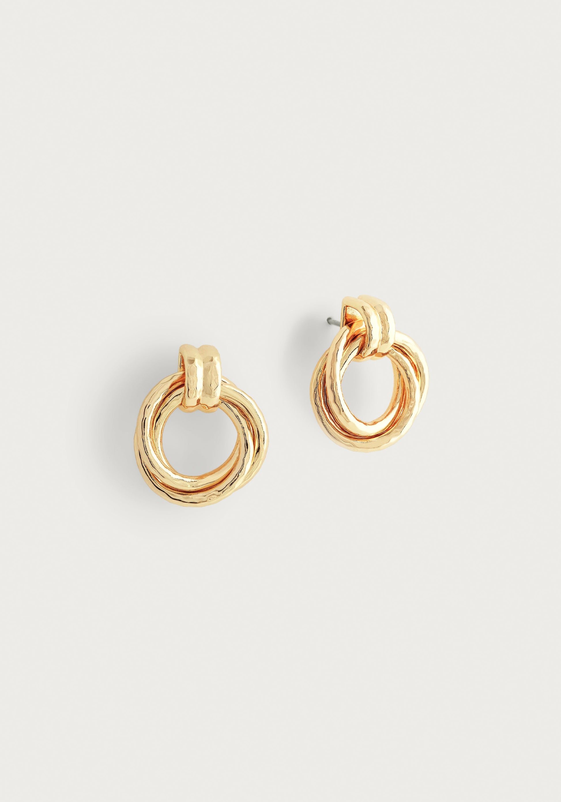 The Anabel Aram Neptune Triple Ring Earrings, minimalist gold studs with a triple ring design, are shown against a plain white background.