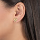 Gold Heart Radiant Stud earring worn on an earlobe.