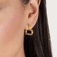 Small Heart Hoop Earrings in 18K gold-plated metal worn in an earlobe.