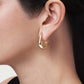 Anabel Aram Milos Fish Hoop Earrings, shaped like a fish and crafted in 18K gold plate, worn in an earlobe.