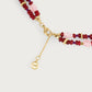 Anabel Aram Milos Beaded Necklace featuring double strands of red, purple, and light pink beads with gold-tone spacers, a lobster clasp, a branded charm, and lapis lazuli and turquoise accents.