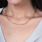 The Anabel Aram Milos Multi Beaded Necklace is a delicate 18k gold plated piece featuring small, smooth, elongated beads spaced along the strand.