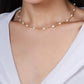 Anabel Aram Milos Multi Beaded Necklace featuring small, evenly spaced white pearls on an 18k gold plated chain worn around the neck.