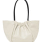 A cream-colored, 100% leather Proenza Schouler Large Ruched Tote with a gathered opening and black handles.