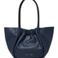 A navy blue 100% leather Proenza Schouler Large Ruched Tote with a gathered opening and a single shoulder strap, featuring a small logo on the lower front.