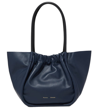 A navy blue 100% leather Proenza Schouler Large Ruched Tote with a gathered opening and a single shoulder strap, featuring a small logo on the lower front.