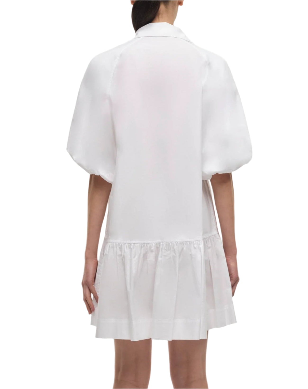 A woman is seen from the back wearing the Simkhai Crissy Dress, a mini dress with puffed sleeves and a ruffled hem in casual shirting fabric, set against a plain background.