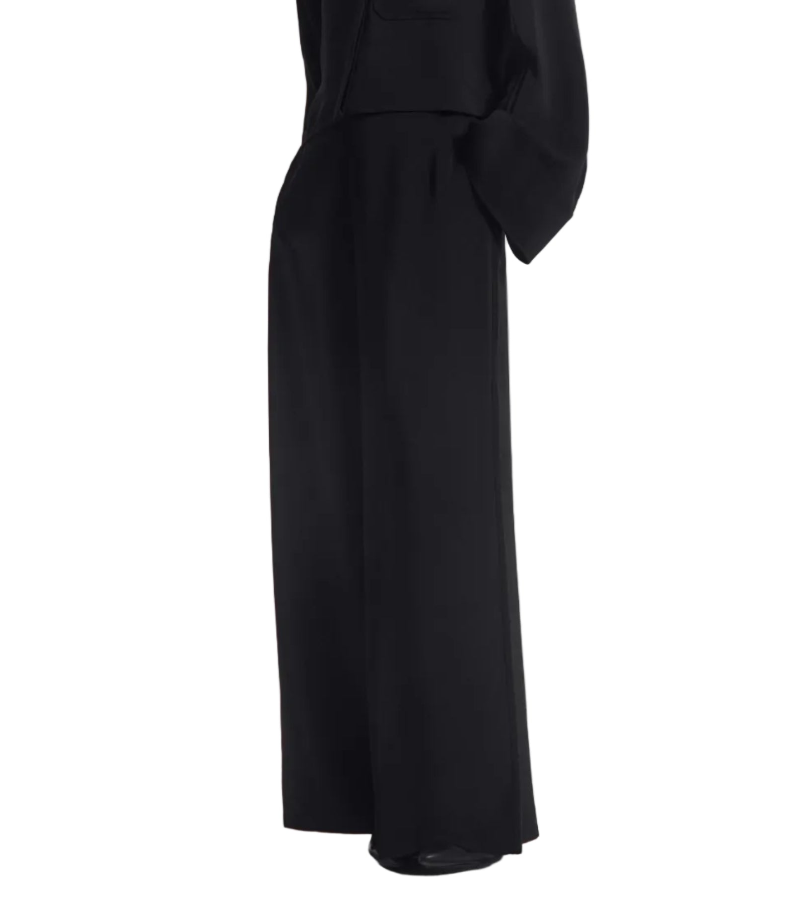 A person wearing the CO Wide Leg Crepe Pant and a black long-sleeve top, photographed from the side against a white background.
