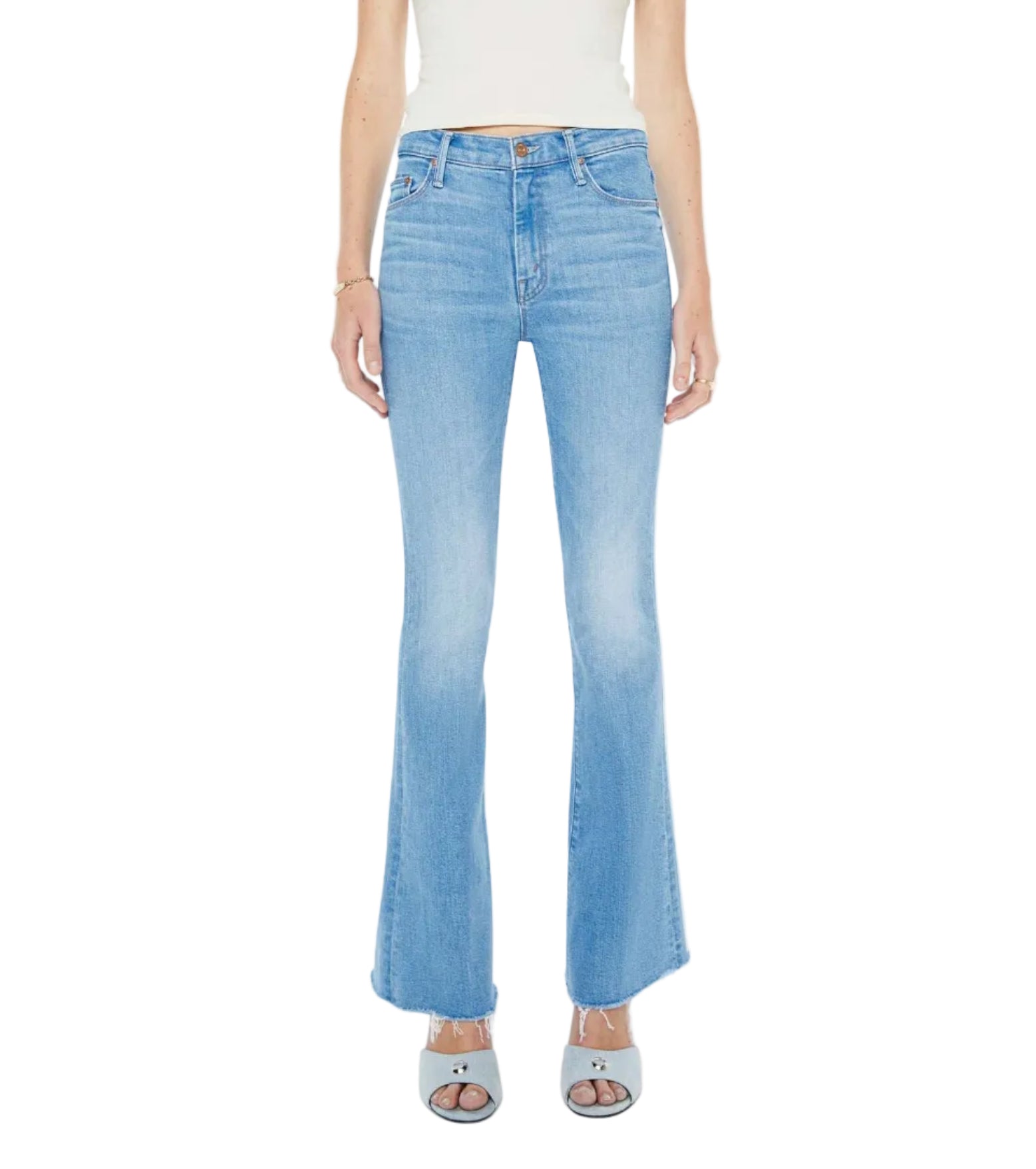 A person wearing The Weekender Fray mid-rise flare jeans by Mother, crafted from recycled stretch denim in light blue, paired with open-toe heeled shoes and shown from shoulders to feet against a plain background.