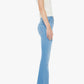 Woman in a short-sleeved white top, Mother’s The Weekender Fray mid-rise flare jeans crafted from recycled stretch denim, and heeled sandals stands in profile against a plain white background.
