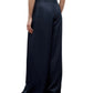 A person is shown from the back against a white background wearing TWP’s Drew Coated Viscose Linen Pant, styled with a sleeveless top.