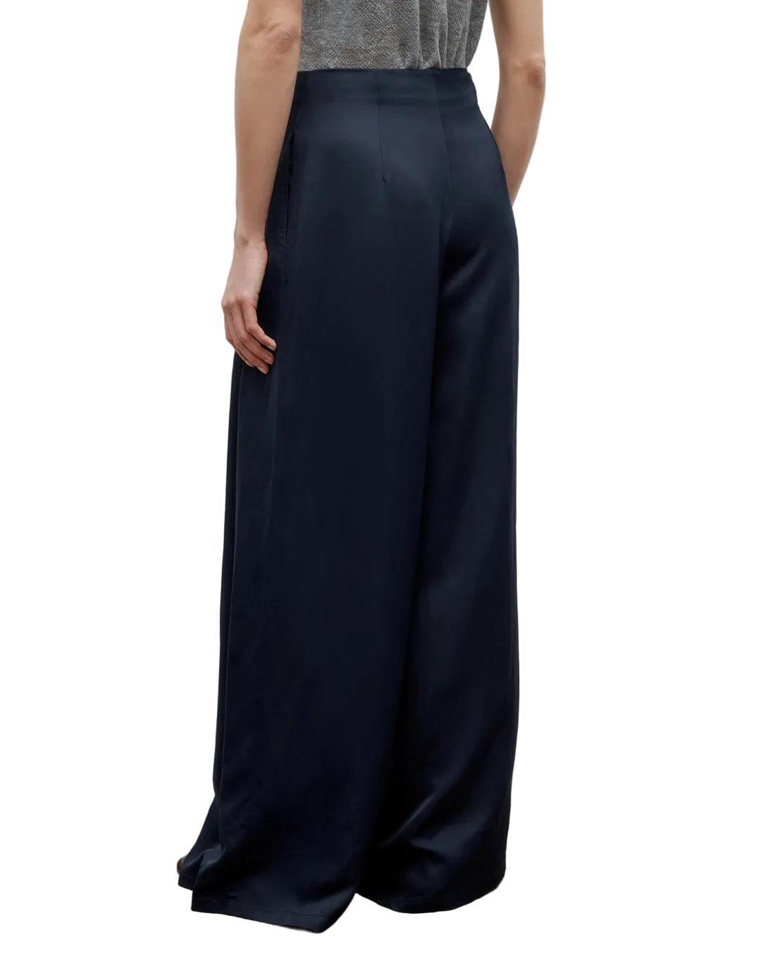 A person is shown from the back against a white background wearing TWP’s Drew Coated Viscose Linen Pant, styled with a sleeveless top.