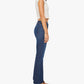 A woman stands in profile against a plain white background, wearing The Weekender mid-rise high-waisted flare jeans by Mother, paired with a white short-sleeve crop top and brown heeled sandals.