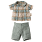 Maileg’s Rabbit, Size 1 – Classic, wears a blue and beige plaid short-sleeved shirt with light green shorts, crafted from soft natural fabrics—ideal for dressing up your rabbit. Outfit is shown on a white background.