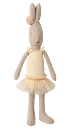 The Maileg Rabbit Size 1, Classic, is standing upright against a plain white background, dressed in a cream ballet suit with a matching tulle skirt and a floral headband, reminiscent of a tiny ballerina.