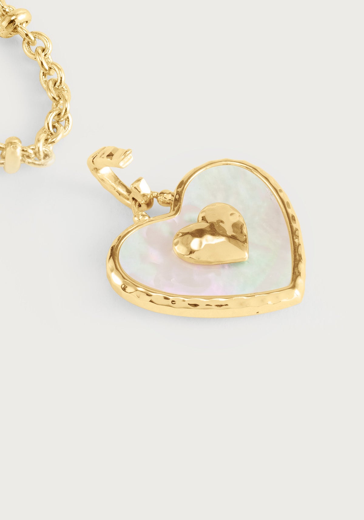 Anabel Aram Heart Radiant Charm featuring a gold-rimmed iridescent inlay with a raised gold heart in the center, attached to a gold chain link.