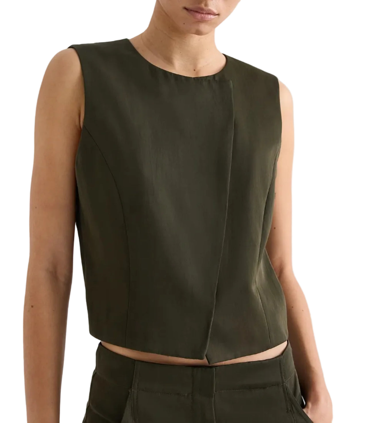 A person wearing the TWP High Neck Hidden Placket Vest in dark olive green with matching pants stands against a plain light background.