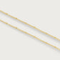 The Molten Bead Chain Necklace in gold by Anabel Aram features two thin molten chains with small, evenly spaced bead accents, displayed against a plain white background.