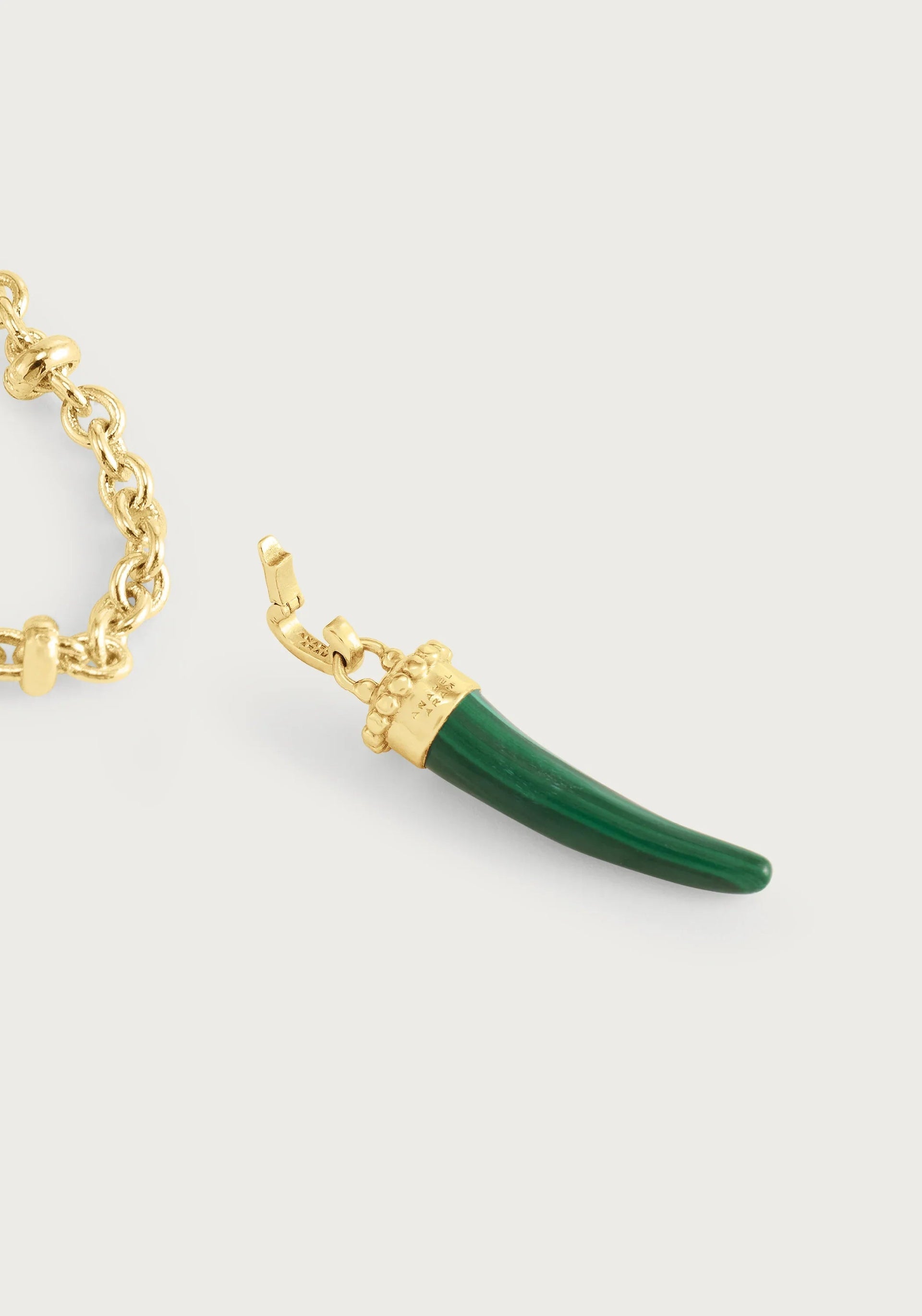 The Milos Stone Horn Charm by Anabel Aram features a green stone pendant with a gold cap and clasp on a gold chain, shown on a white background—a striking Mediterranean accessory to elevate any look.