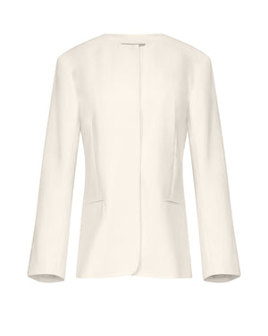 The TWP Cecelia Jacket is a women's long-sleeve, off-white blazer made from 100% linen. It features a collarless design and no visible buttons, showcased on a white background.