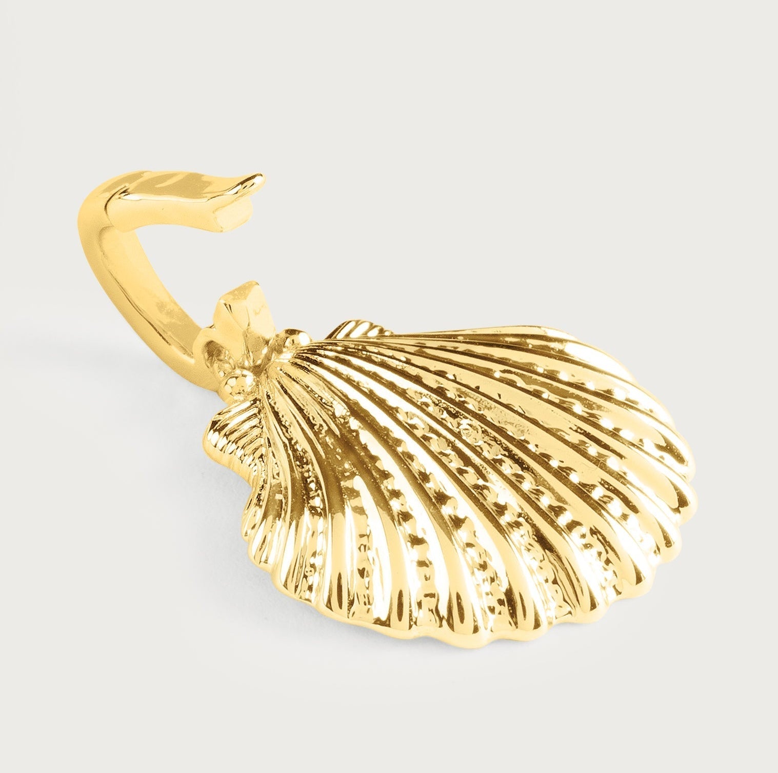 The Anabel Aram Scallop Shell Charm is a gold-toned metal keyring inspired by ocean jewelry, shown against a plain light background.