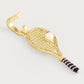 The Anabel Aram Tennis Racket Charm is a gold-plated earring with blue enamel on the handle and a pearl accent as the ball.