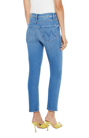 The image shows someone from behind wearing Mother Denim The Tomcat Ankle jeans in mid-blue and yellow high heels against a plain white background.