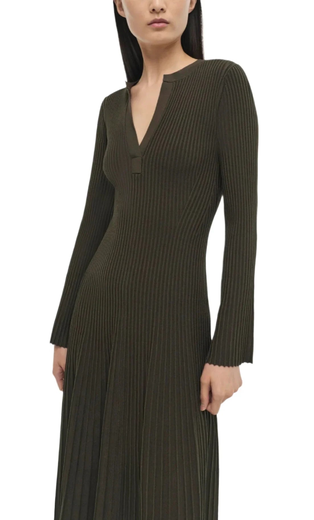 Woman wearing a long-sleeved, olive green Simkhai Genna Dress with a plunging neckline.