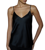 A person wearing a 100% silk black satin spaghetti strap top, the Sablyn Gloria Silk Cami, stands against a plain white background.