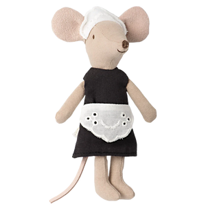 Add charm to your kitchen display with Maileg's Maid Mouse, Big Sister—a stuffed toy mouse in a black dress, white eyelet apron, and white bonnet, standing upright for a delightful housekeeping touch.