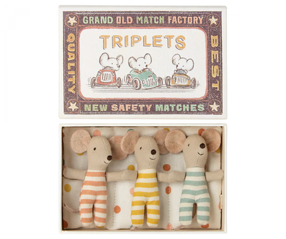 The Maileg Baby Triplets in Box, an ideal gift for kids, comes in a matchbox labeled "TRIPLETS" and features charming illustrations of mice driving cars. Inside, you'll find three adorable baby mice triplets dressed in orange, yellow, and green striped outfits. These delightful toys are crafted from recycled polyester by Maileg, making them an eco-friendly choice.