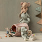 Three Maileg Hiker Mouse, Big Brother dolls are arranged with plush elephants, a fabric basket, assorted toys, and a tea set on a neutral background, complemented by a decorative pennant banner on the wall.