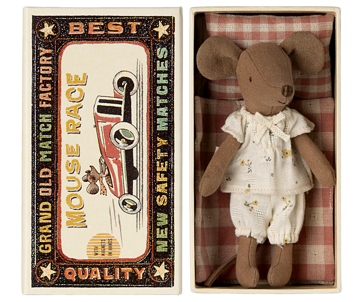 The Maileg Big Sister Mouse in Matchbox - Pyjamas comes dressed in white pajamas and rests in a vintage-style box, making it a charming collectible for any soft toy enthusiast.