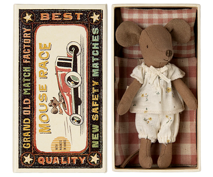 The Maileg Big Sister Mouse in Matchbox - Pyjamas comes dressed in white pajamas and rests in a vintage-style box, making it a charming collectible for any soft toy enthusiast.