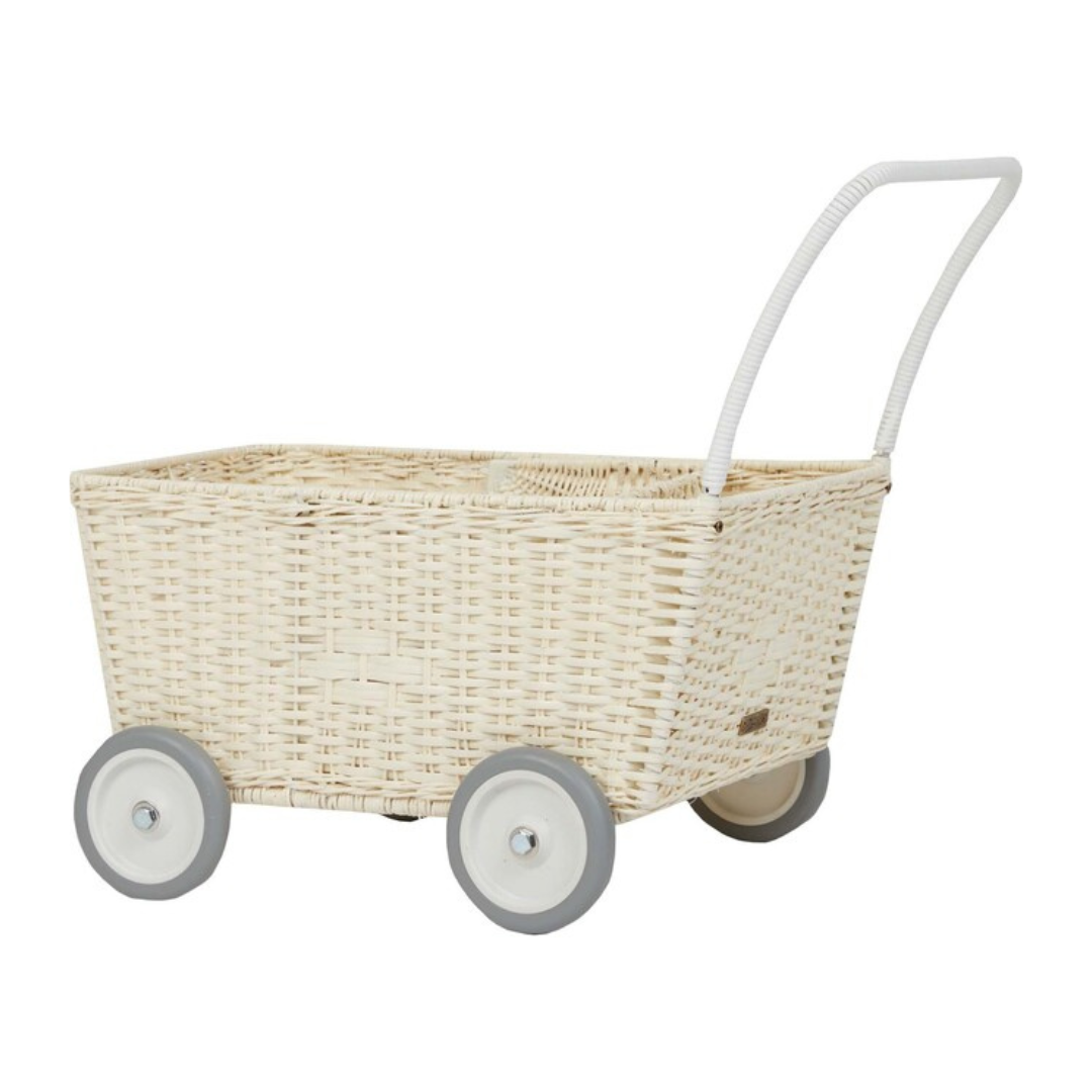 A hand-woven Olli Ella Rattan Strolley with a white handle, isolated on a white background.