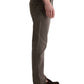A person stands in side view against a plain background, wearing AG Jeans' Tellis Modern Slim Denim in Hyper Soft Bull Denim, paired with a white shirt and brown loafers.