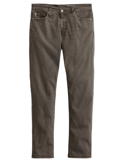 A pair of Tellis Modern Slim Denim jeans by AG Jeans in brown Hyper Soft Bull Denim, featuring a five-pocket design and straight-leg fit, displayed flat on a white background.